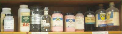 Stoichiometry Help Page - Bottles of Chemicals on Shelf